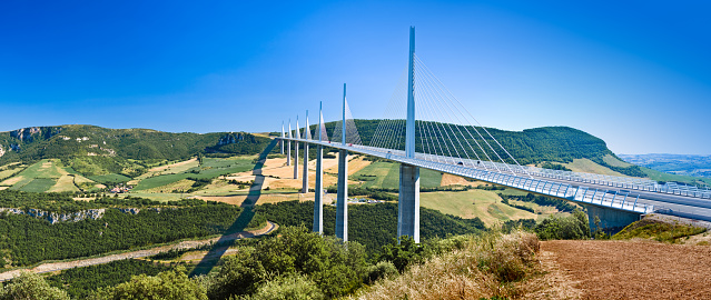 The spectacular Millau Viaduct bridge in South of France, on a gorgeous sunny day. This editorial image was taken on 07/28/2017 in the region of Millau, France.