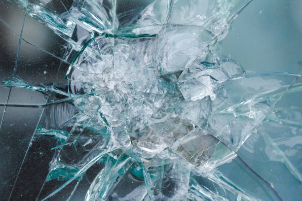 istock Firearms bullethole on the glass from the bullets, cracks background 649425372