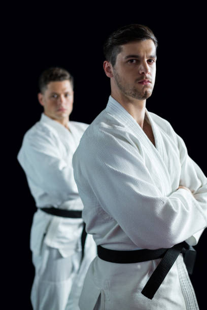istock Karate players standing with arms crossed 649431218