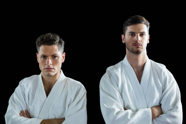 istock Karate players standing with arms crossed 649431274