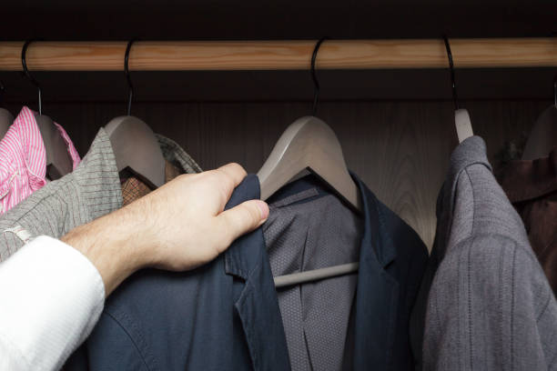 istock Man chooses clothes, rummaging in the cupboard 649441562