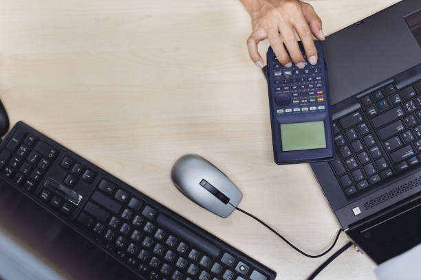 istock Top view of Senior design engineer calculating about engineering and take note in selective focus. calculator, laptop, monitor on working desk.man hard working. 649448070