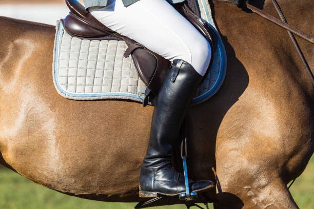 istock Horse Rider Saddle Leg Boot Closeup Abstract 649453794