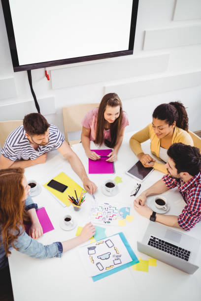 istock High angle view of colleagues discussing in meeting at creative office 649456418