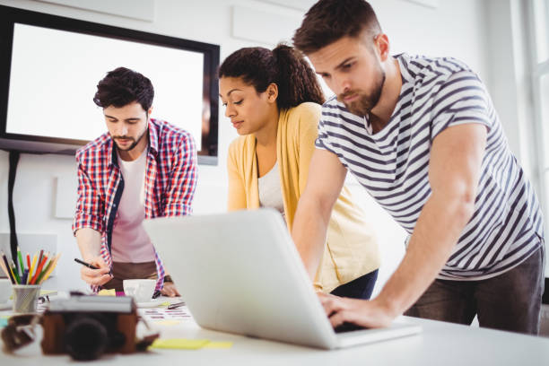 istock Coworkers working in meeting at creative office 649456964