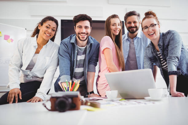 istock Portrait of cheerful editors standing at creative office 649457892