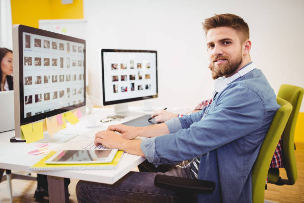 istock Portrait of confident editor working in creative office 649458428