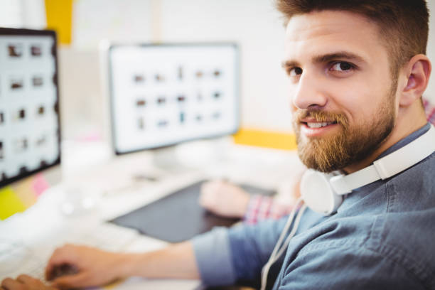 istock Portrait of confident photo editor working at creative office 649458452