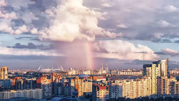 High quality and resolution photo with urban view on New Stadium in Saint-Petersburg Russia constructed for events like FIFA World Cup 2018, UEFA Euro 2020, FIFA Confederations Cup 2017 and other events. Rainy weather clouds and rainbow makes beautiful look on sunset.