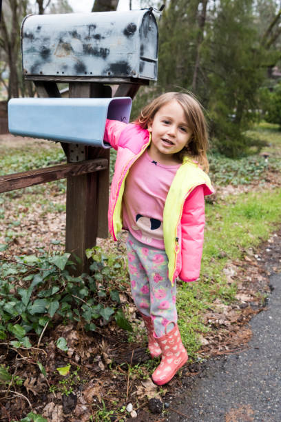 istock Little girl posing near a mailbox 649474244