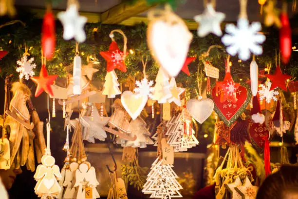 Shaped hanging ornaments to act as Christmas decorations on sale at Lincoln Christmas market. They are in the shape of stars, christmas trees, angels and hearts.