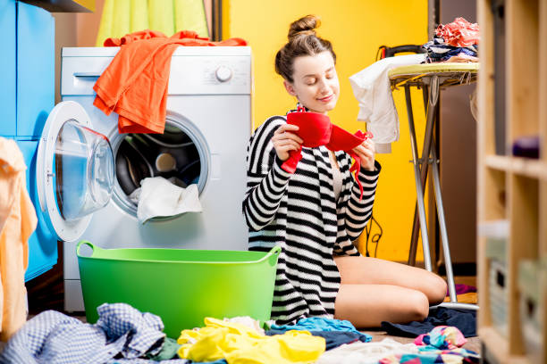 istock Woman washing clothes at home 649488734