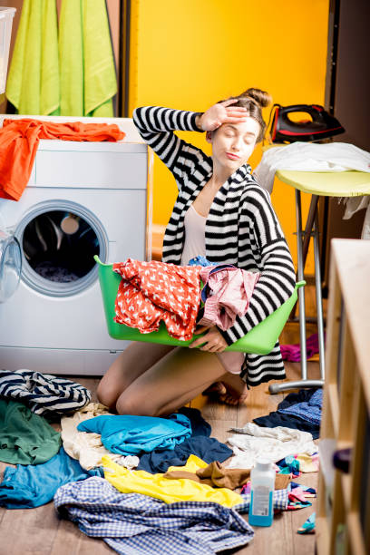 istock Woman washing clothes at home 649493194