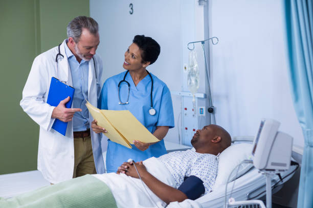 istock Doctor and nurse discussing report during visit in ward 649496270