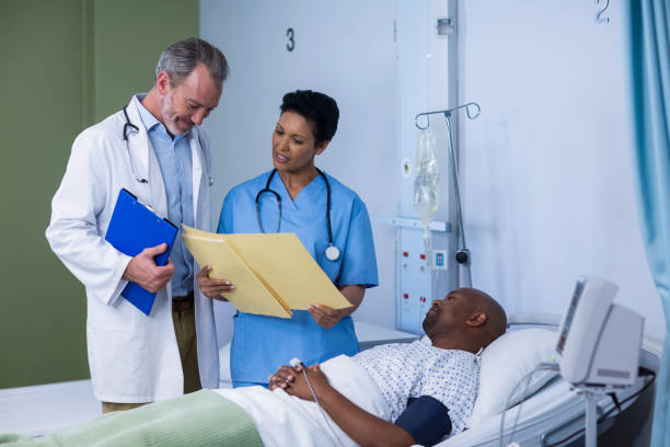 istock Doctor and nurse discussing report during visit in ward 649496334