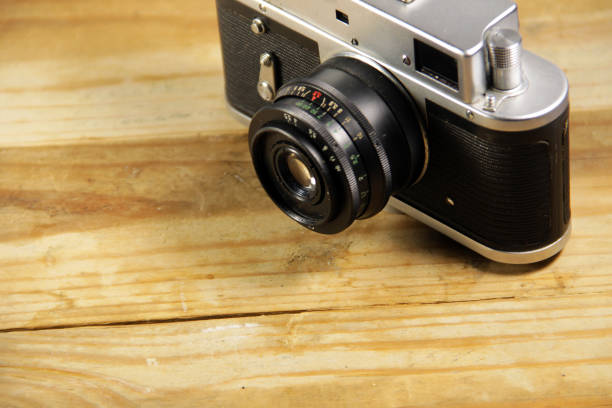 istock Retro photo camera on wooden background 649503000