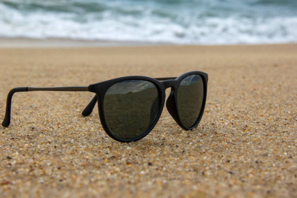 istock Sunglasses at the edge of the beach. 649503300