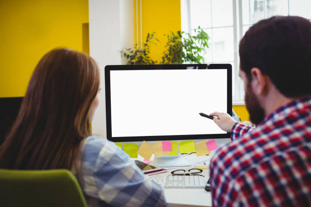istock Rear view of business people with computer 649511378