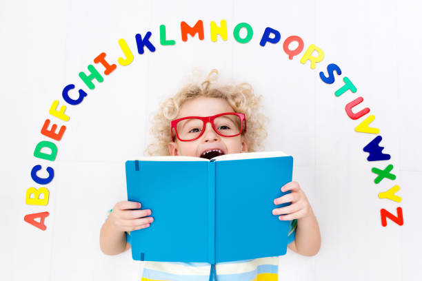 istock Child learning letters of alphabet and reading 649515198