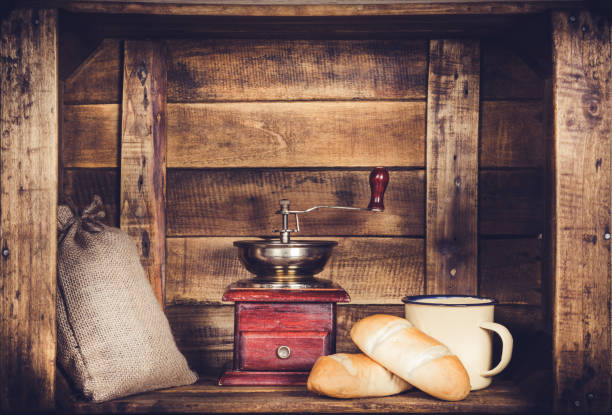 Coffee Mill Cup and burlap with coffee bean sack and bread on wooden window-shaped box