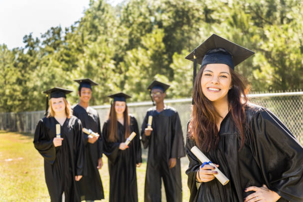 istock Latin descent college, high school student with diploma at graduation. 649525726