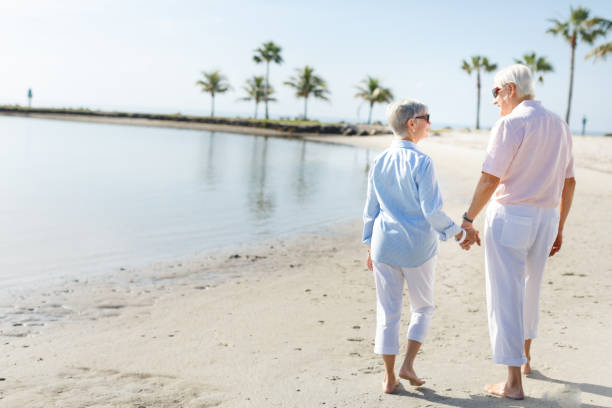 istock Senior couple walking at the beach 649528250