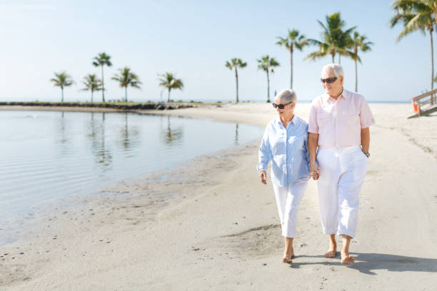 istock Senior couple walking at the beach 649528548