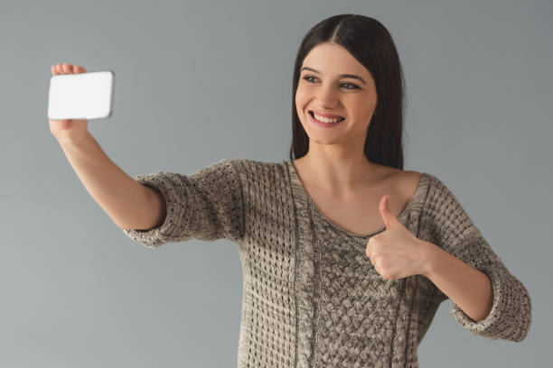istock Attractive young woman with gadget 649528770