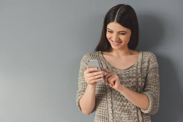 istock Attractive young woman with gadget 649532410