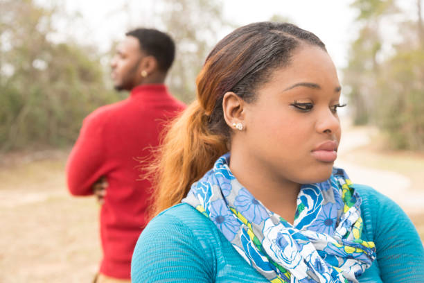 istock Sad African descent couple in park setting after argument. 649541266