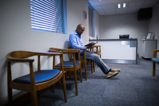 istock Patient reading magazine in corridor 649541414