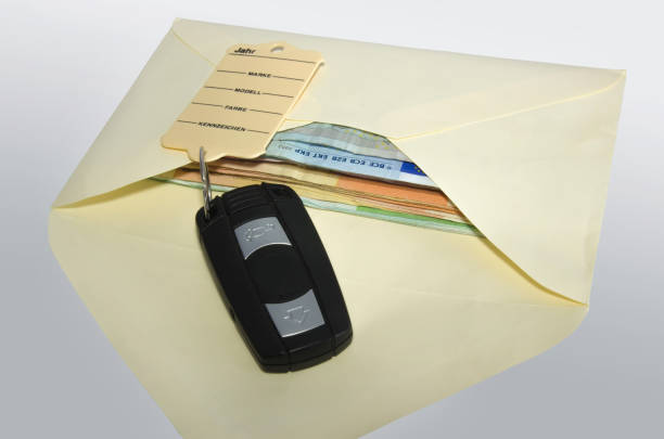 istock Money in an envelope and a car key 649541850