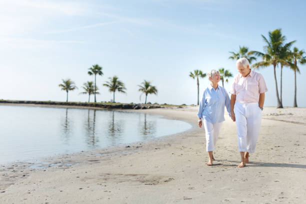 istock Senior couple walking at the beach 649543996