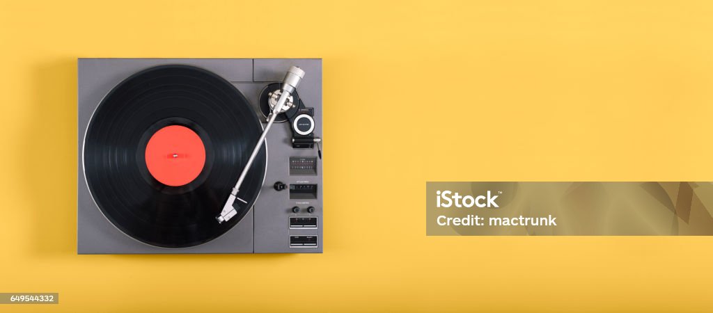 Retro record player An old record player header image on yellow background with copy space Turntable Stock Photo