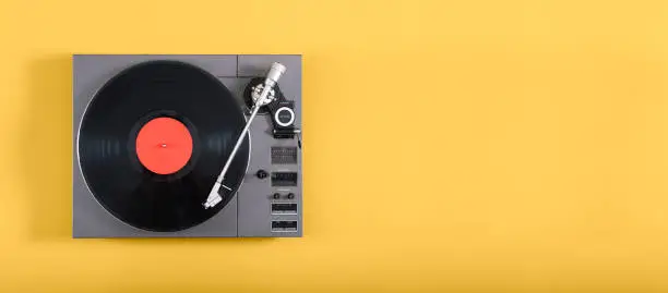 An old record player header image on yellow background with copy space