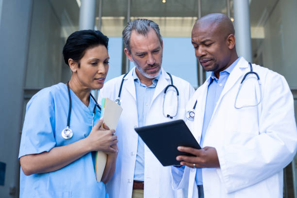 istock Surgeons and nurse having discussion on digital tablet 649544410