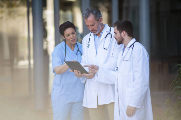 istock Surgeons and nurse having discussion on digital tablet 649544630