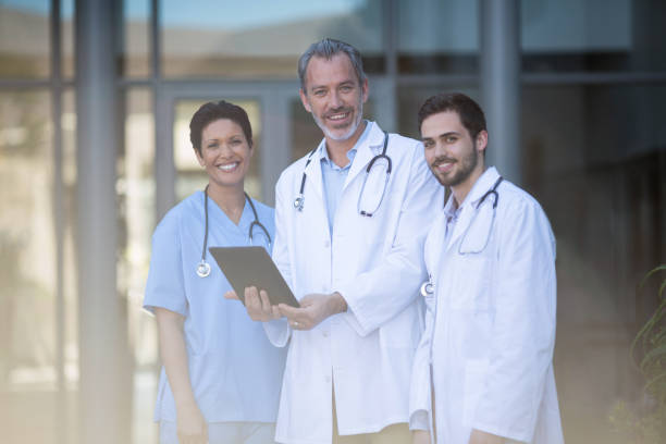 istock Portrait of nurse and surgeon using digital tablet 649544636