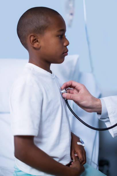 istock Doctor examining a child with stethoscope 649544810