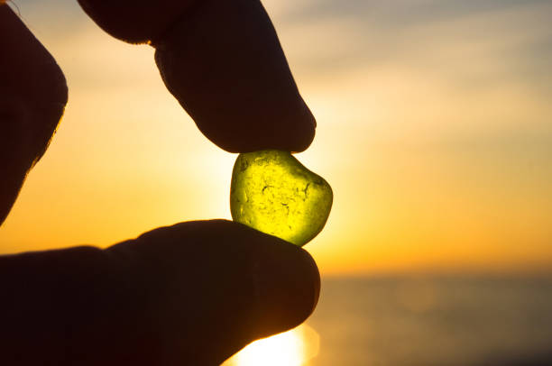istock sea smoothed green glass in hand 649545010