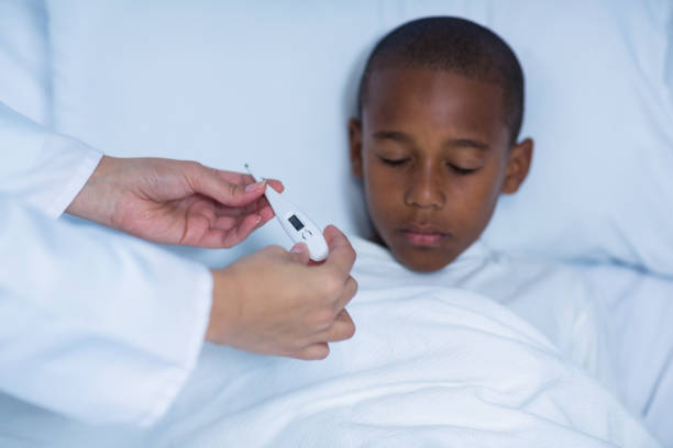 istock Female doctor checking fever from digital thermometer 649549638