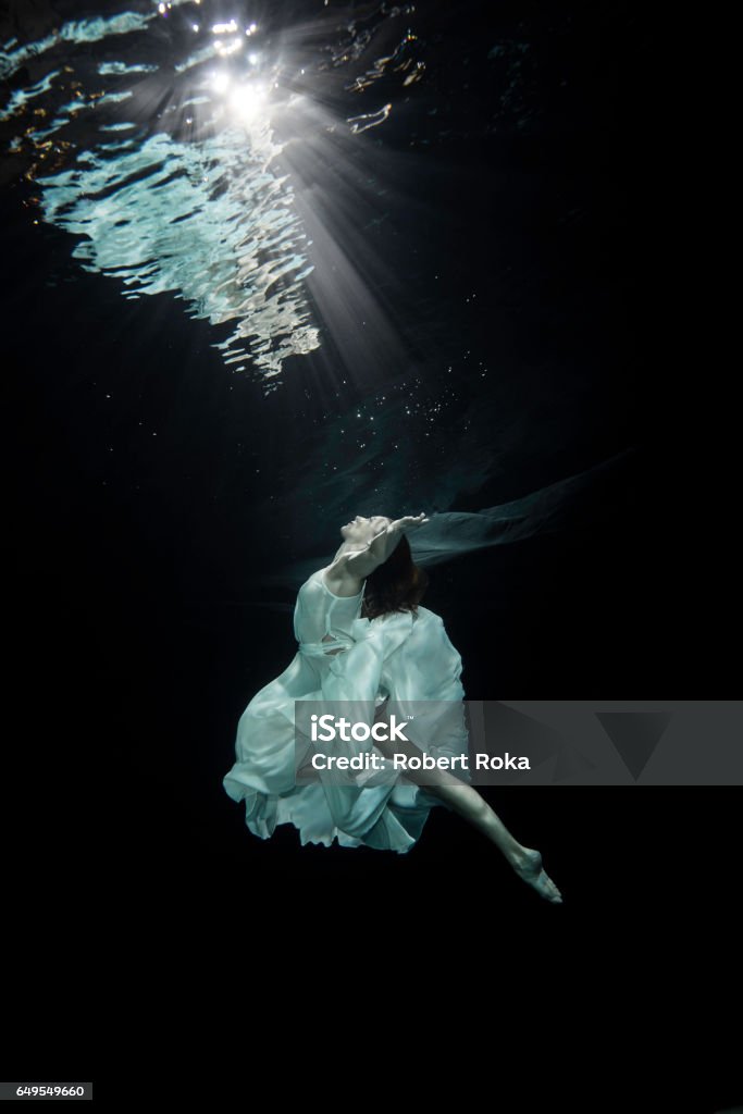 Young female ballet dancer dancing underwater Underwater Stock Photo