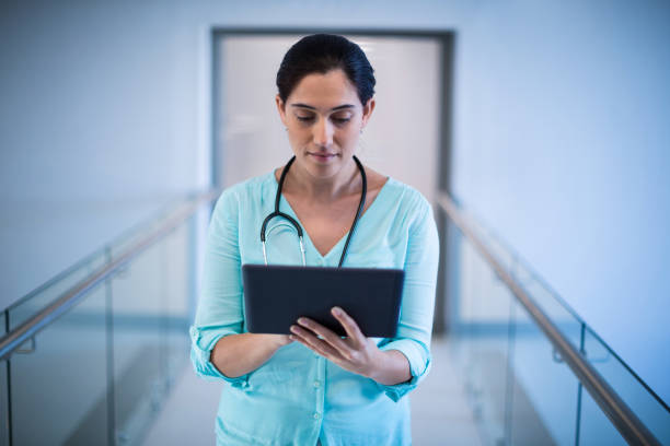 istock Female doctor using digital tablet in corridor 649552052