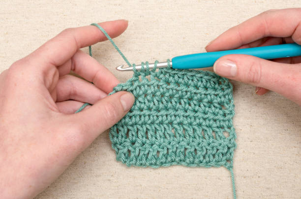 Crocheting Stitching Teal Yarn Knitting Hook Crochet double stitching with teal yarn Crochet stock pictures, royalty-free photos & images