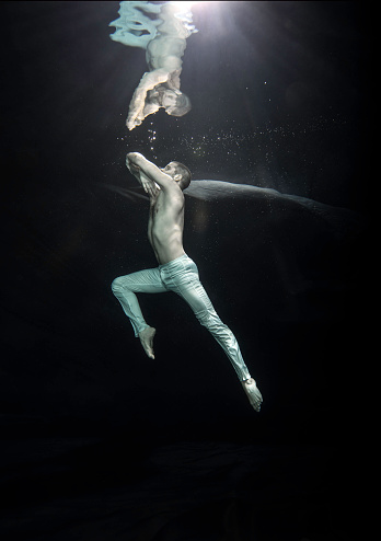 young male ballet dancer unerwater