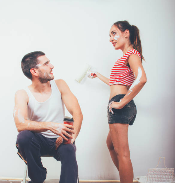 istock Young couple painting the wall 649559328