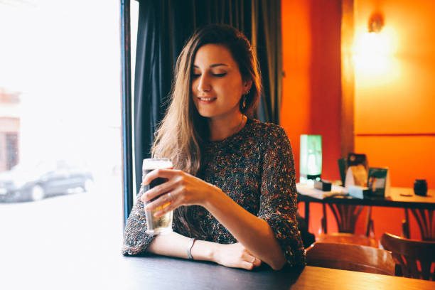 istock Woman relaxing and having a drink in Belgrade pub 649570794