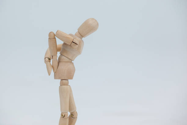 istock Wooden figurine standing with hands on back 649576772