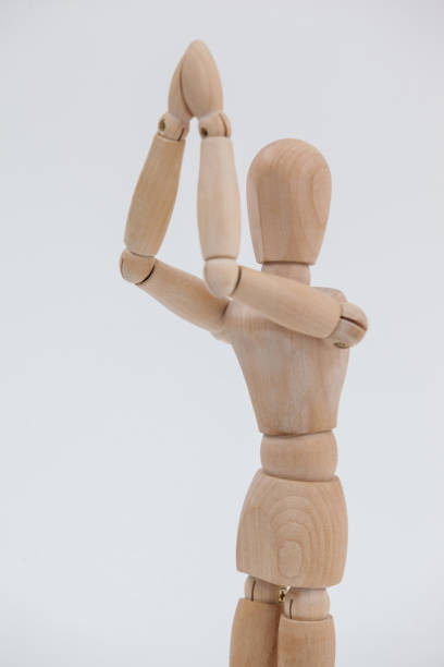 istock Wooden figurine standing with both the hands joined 649579840