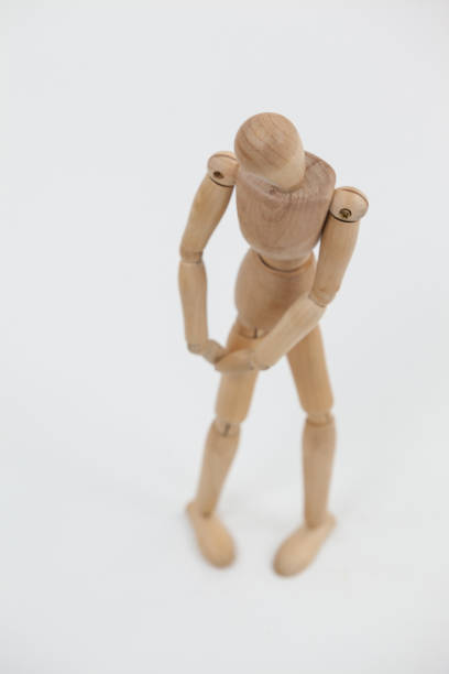 istock Wooden figurine standing with hands on knee 649581170
